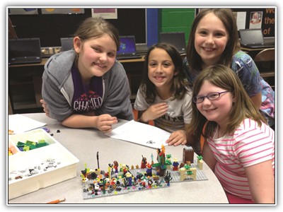 Montour students work together with LEGOs in Burkett Elementary Schools new STEAM room to construct a narrative, which they also write on computers, thereby creating a cross-discipline exercise. Photo submitted.   LEGO4